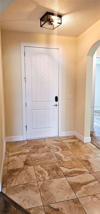 Front entry Foyer with decorative niche and view of open concept Great Room.