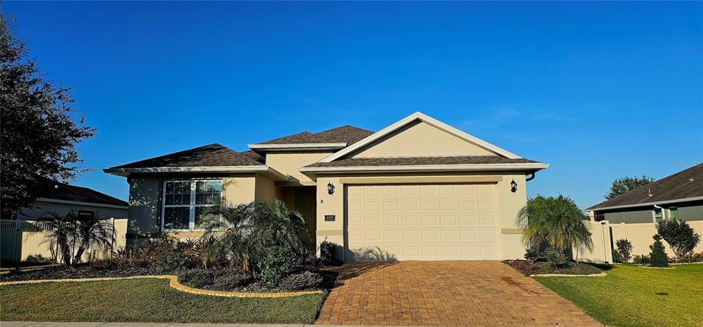 Front Exterior with paved driveway, gutters and covered front porch.