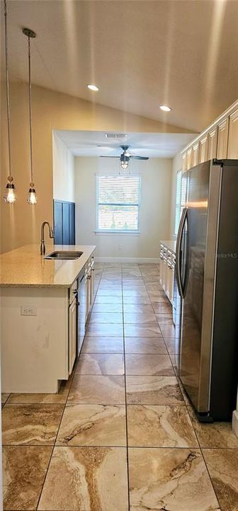 Beautiful open concept Kitchen with huge Quartz breakfast bar, Pendent and recessed lighting, 42" cabinets, SS appliances and separate Breakfast Nook.