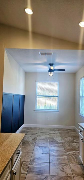 Breakfast Nook with porcelain tiles, and ceiling fan.