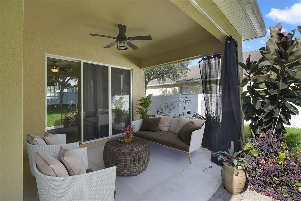 Triple sliding glass doors open up to a COVERED LANAI and the perfect place to cookout - there is even a dedicated area for your grill! Virtually Staged.