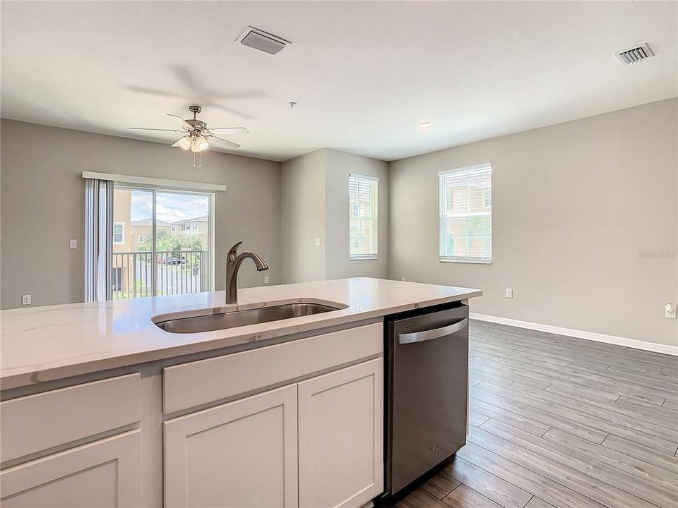 Kitchen that offers quartz countertops, solid wood cabinets, walk-in pantry, and stainless-steel appliances