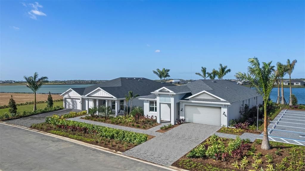 Welcome home! Luxury single-family Montura Coastal model home (Pictured on right) with gorgeous backyard, and water view of Lake Babcock-- Spacious two-car garage, 2,236 square feet (3 Beds, 2.5 Baths, Flex Room)