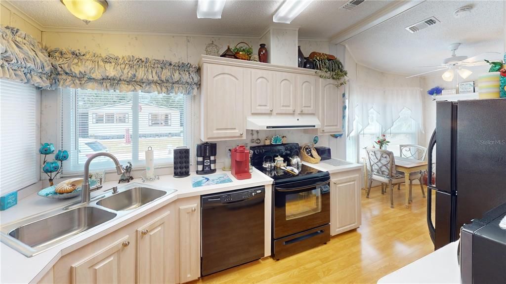 Kitchen offers plenty of cabinets and a pantry.