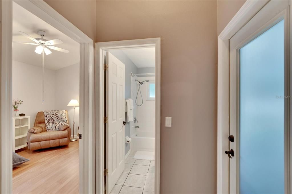 Hallway to bathroom and bedroom with additional door to the lanai