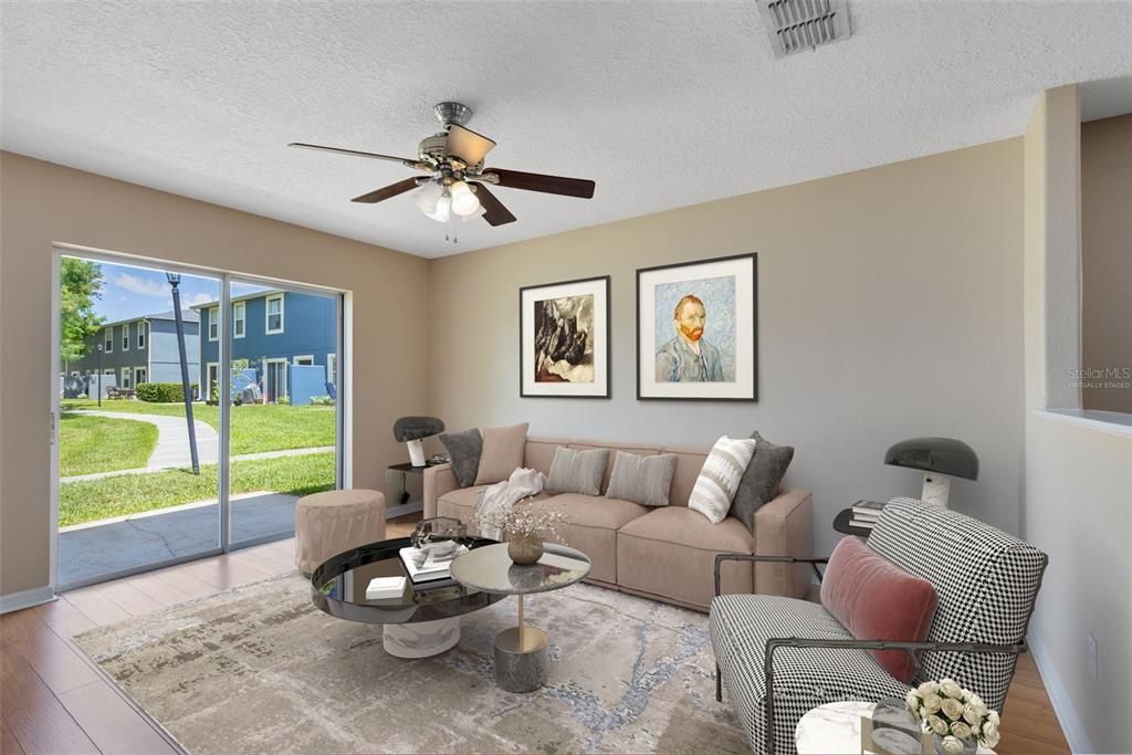 This photo has been virtually staged. Sliding glass doors in the family room lead to your private patio overlooking the picturesque pond – a serene spot for morning coffee or evening unwinding.
