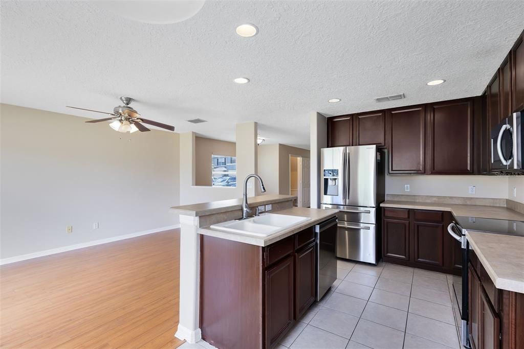 The eat-in kitchen is a chef’s delight, equipped with stainless steel appliances and a breakfast bar for casual dining.