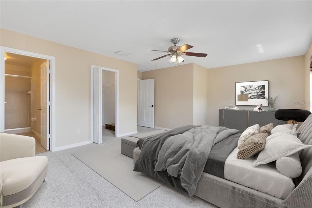 This photo has been virtually staged. Retreat to the expansive master bedroom featuring a walk-in closet and an en suite bathroom with a shower.