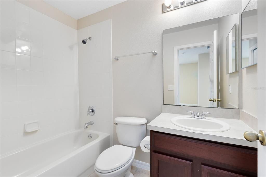 Full guest bath with a tub/shower combo.