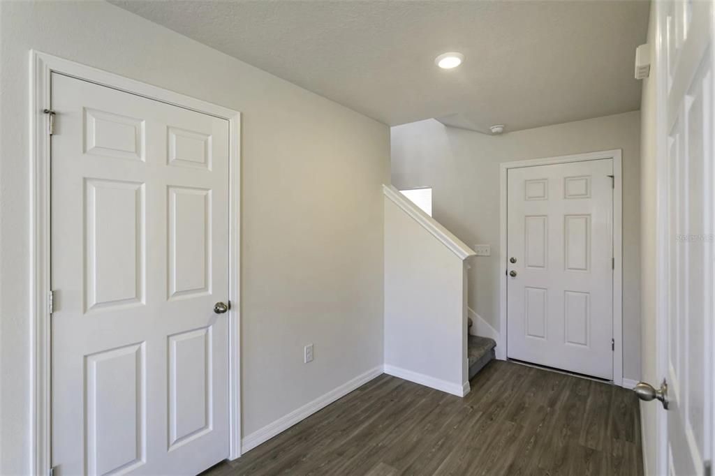 Foyer, Stairs and Door to Powder Bath