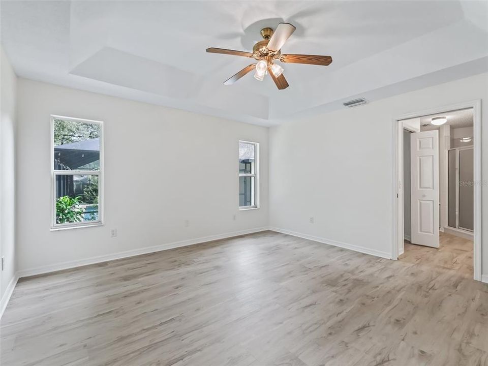 Primary bedroom w/ access to primary bath w/ walk in closet