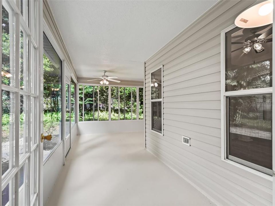 Glassed in Lanai with french doors and ceiling fans