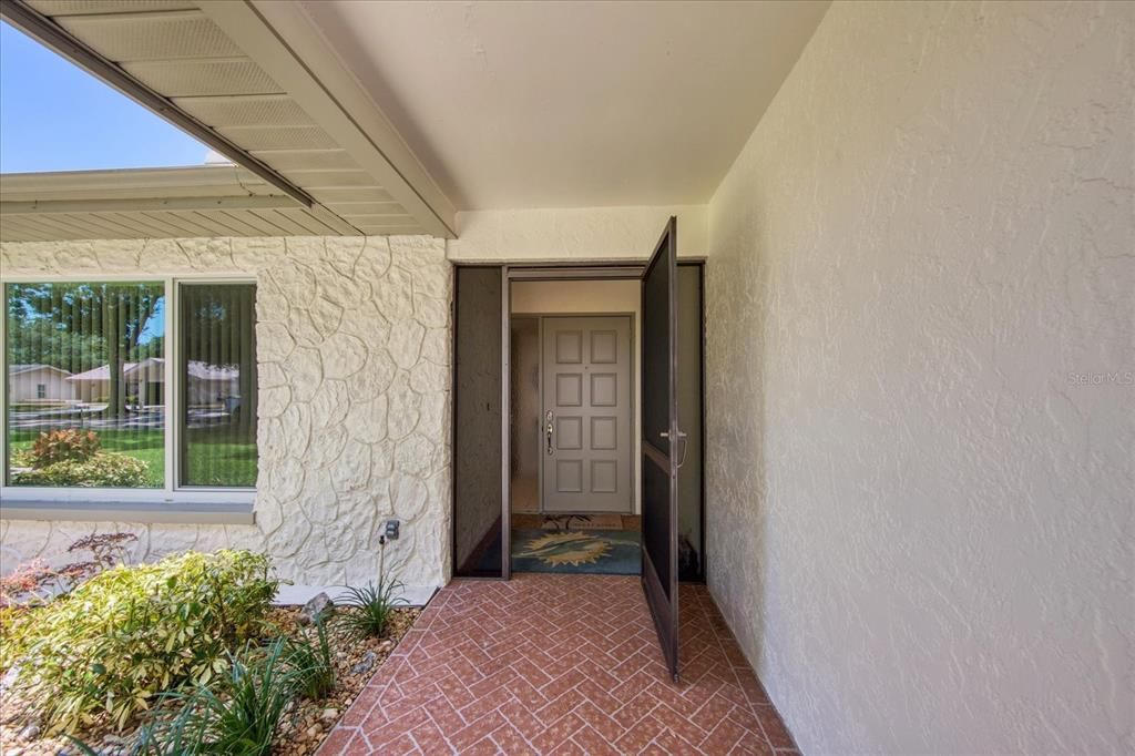 Covered front walkway for a gracious entry~