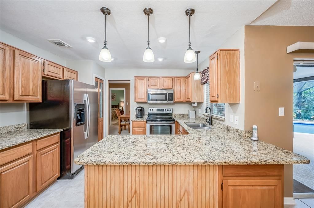 Kitchen - updated lighting, granite countertops, and stainless steel appliances