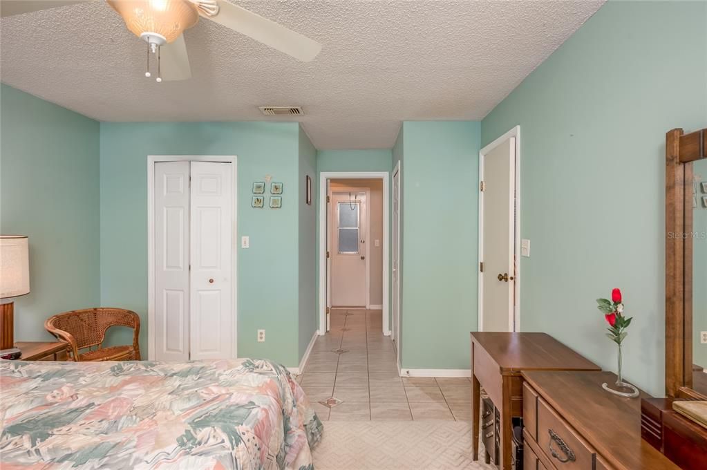 Primary bedroom with walk-in closet and additional wall closet near bathroom