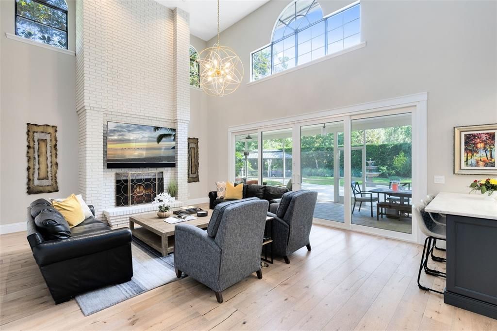 Tall ceilings, floor to ceiling fireplace and newer windows and doors make this a great room to gather.