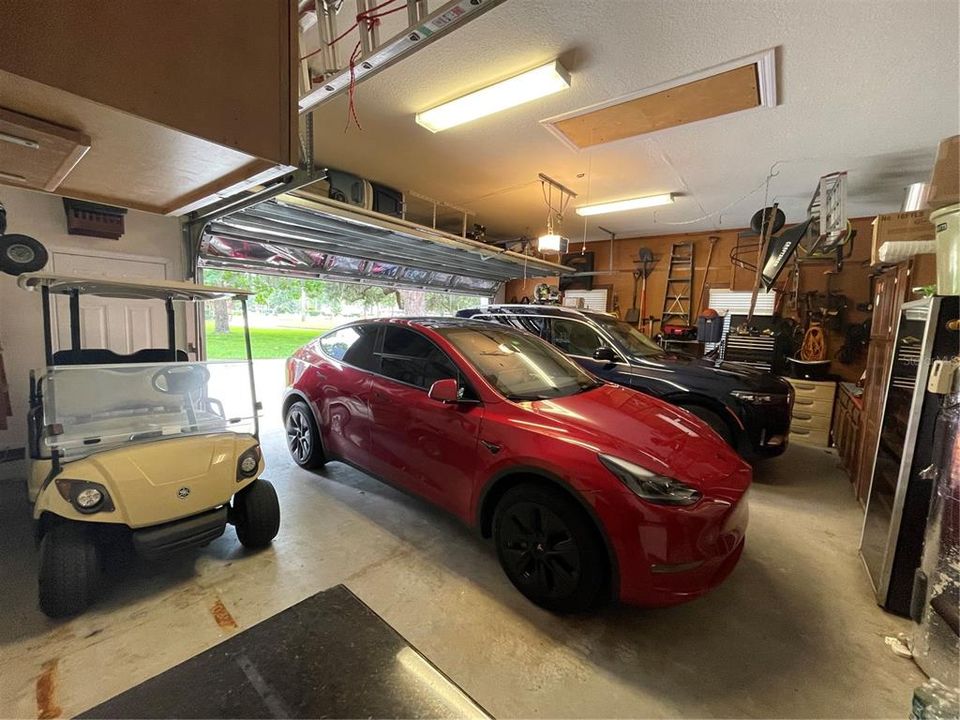 The 2 1/2 car garage can accommodate 2 oversized vehicles and 1 golf cart.