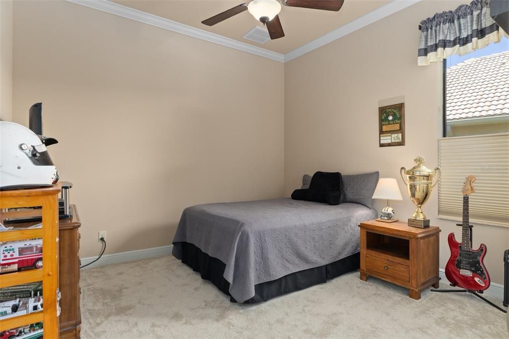 The generous Guest Bedroom provides room for a larger bed and furniture. It also features crown molding.