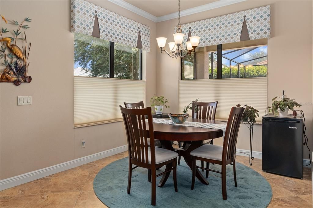 The Dining Area is nestled within its own alcove off the Kitchen and Great Room. The Hunter Douglas pleated shades are Top Down/Bottom Up add versatility to let natural light in, while maintaining privacy.