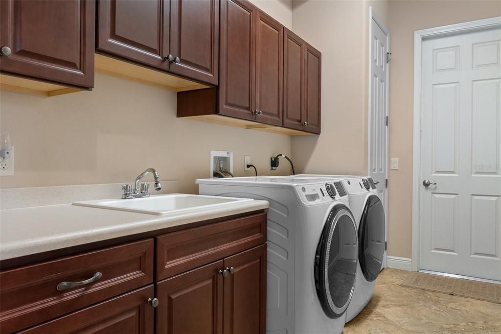 The larger Laundry Room provides additional storage. The owners expanded the laundry room to add a closet. The door on the right leads to the garage.