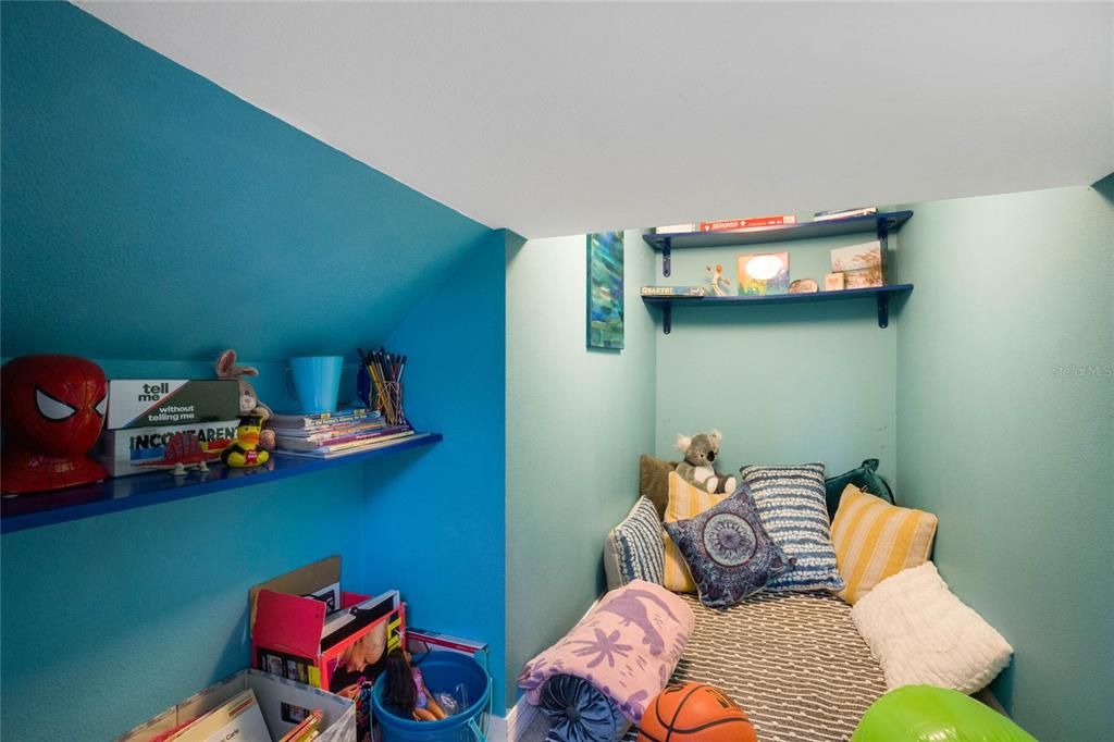 Reading nook under the stairs or extra storage space.