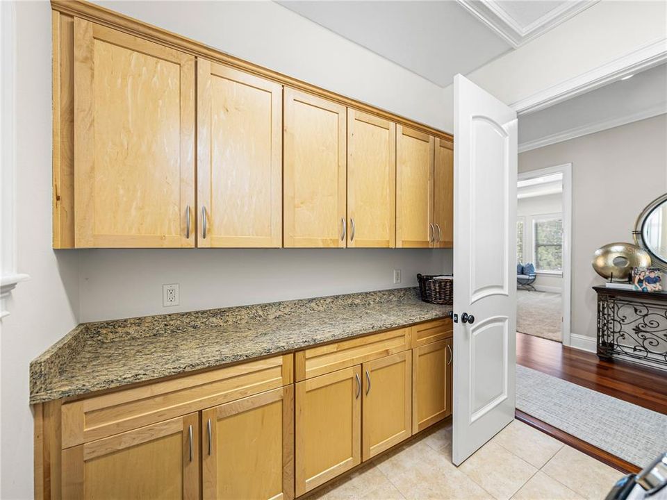 Upstairs laundry room features storage