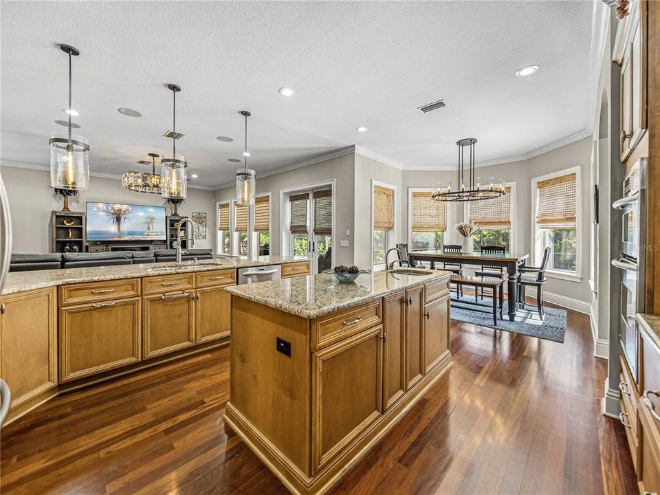 Kitchen features island and dinette that overlooks pool