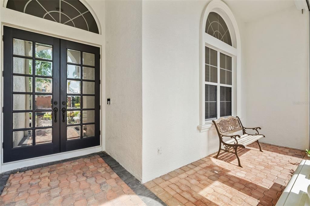 Front of home with covered seating area