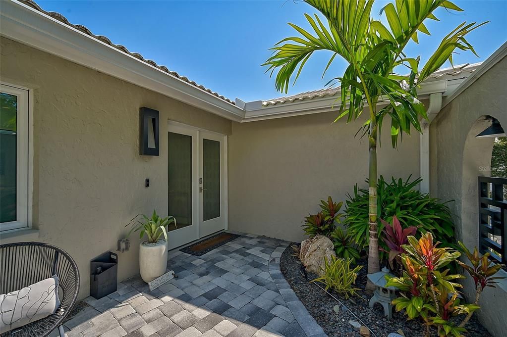 Professionally Curated Courtyard Behind Custom Made Metal Gate