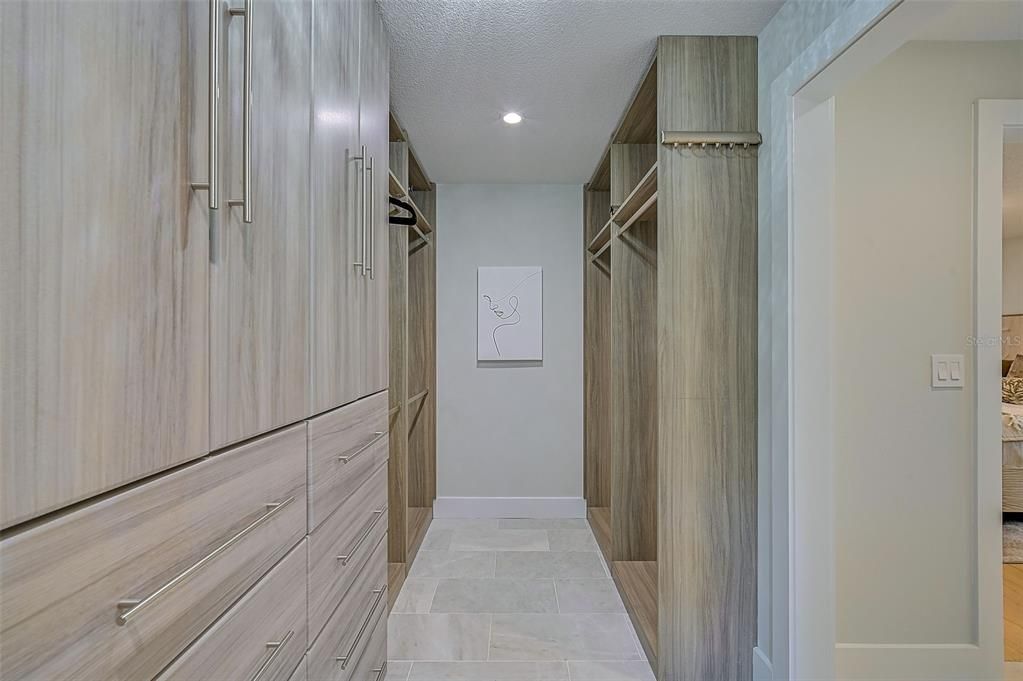 Built Out Master Closet w Custom Cabinets, Drawers, Shoe Shelves, and Marble Floor