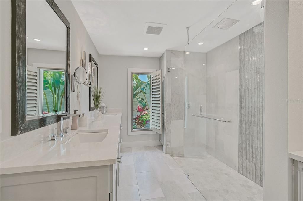 Delgatie Quartz Double Vanity. Rainfall Shower. Tropical Landscaping Views with Bright Natural Light. Large Window w Shutter