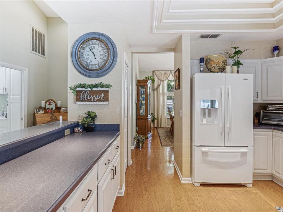 large counter and more cabinets, pantry at the end