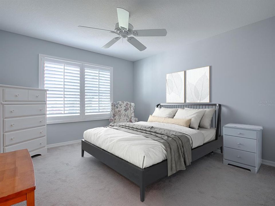 2ND GUEST ROOM WITH CARPET, PLANTATION SHUTTERS AND CEILING FAN.  THE BED AND PICTURES OVER THE BED IN THIS PHOTO ARE VIRTUALLY STAGED.