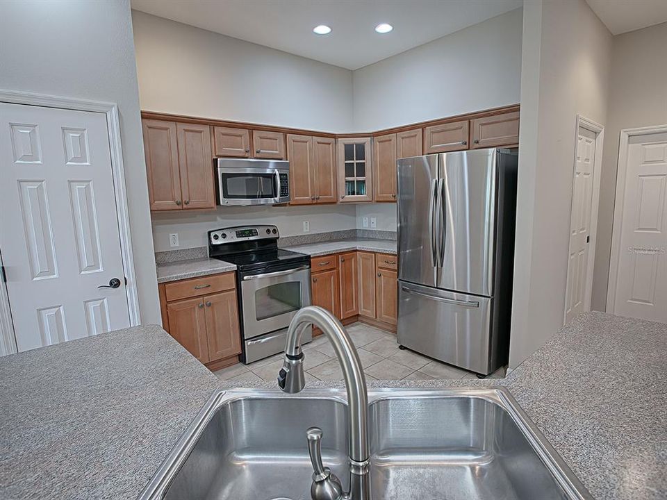 CHERRY CABINETRY AND HI-DEFINITION BEVELED EDGE LAMINATE COUNTERTOPS.