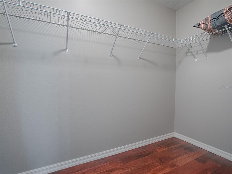 LARGE WALK-IN CLOSET WITH PLENTY OF ROOM FOR MORE SHELVING AND STORAGE.