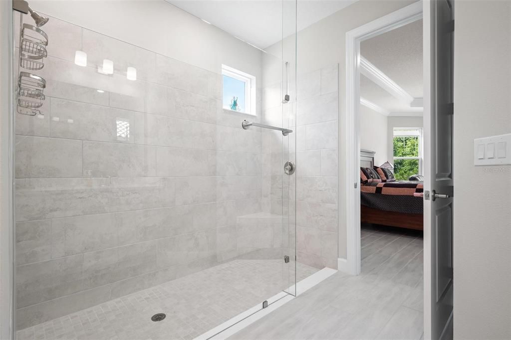 The massive shower is complemented with the stunning upgraded seamless glass.