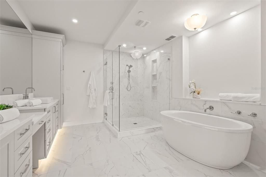 The owner's bathroom is luxurious, with two sinks, a vanity, a large walk-in shower, and a soaking tub....