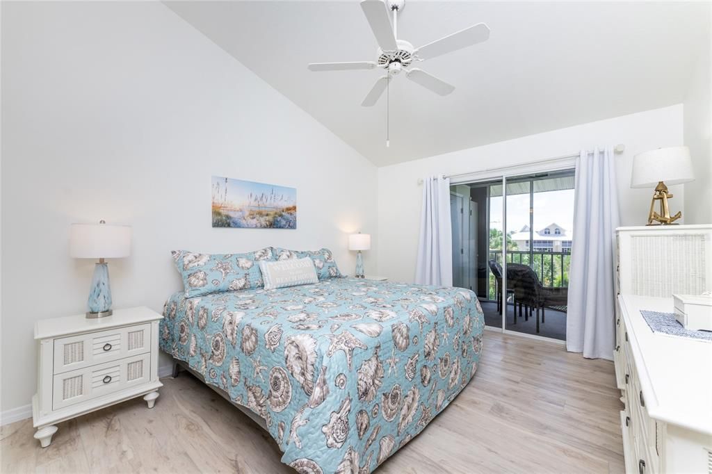 Master bedroom has a vaulted ceiling and ceiling fan, laminate flooring plus sliding glass doors to the lanai!