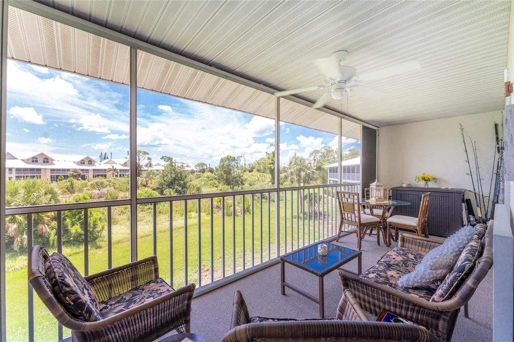 Vinyl enlcosed and Screened lanai has a natural view of the Wildflower Preserve.