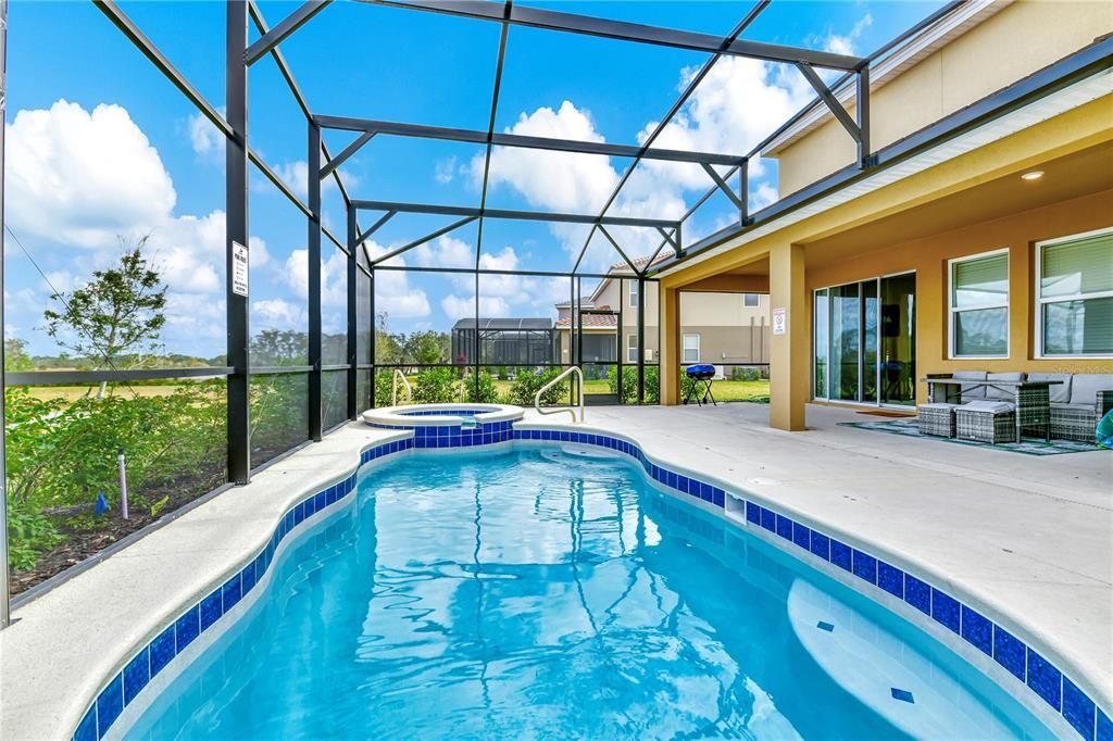 Screened in Pool area with heated Pool & Spa