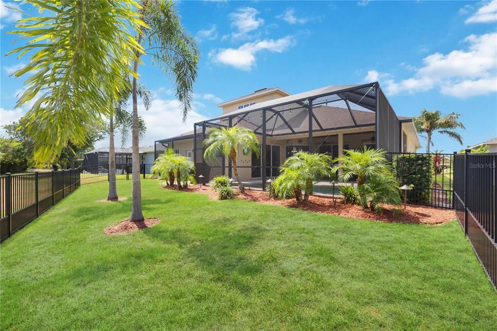 Oversized Backyard surrounded by Florida palms, fenced, a true oasis a great home for family, guests and the fur babies.