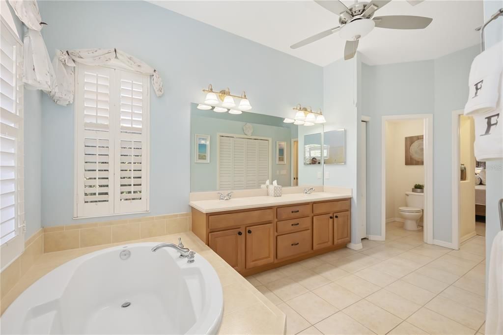 Ensuite bathroom with walk in shower and oversized soaking tub, walk-in shower, dual vanities.