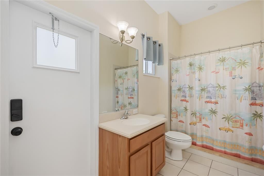 Third bathroom that connects to lanai and pool area with walk-in shower.