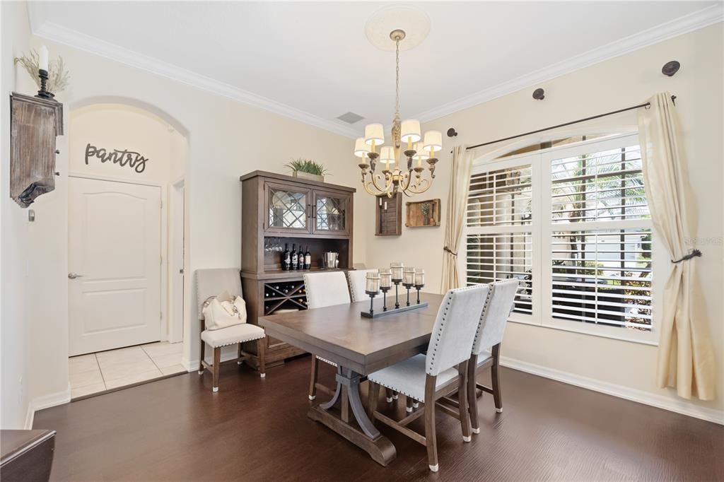 Formal dining area with modern and polished light fixtures ceramic tile flooring.