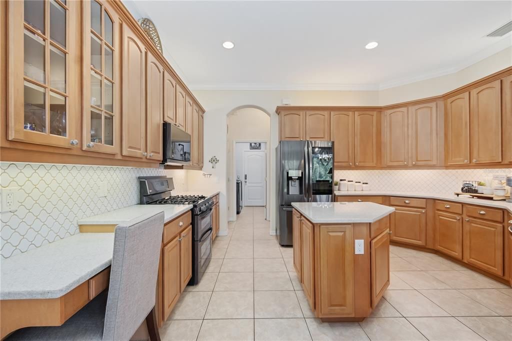 Spacious kitchen designer backsplash, Breakfast bar large enough for 2-3 people as well as a desk built-in.