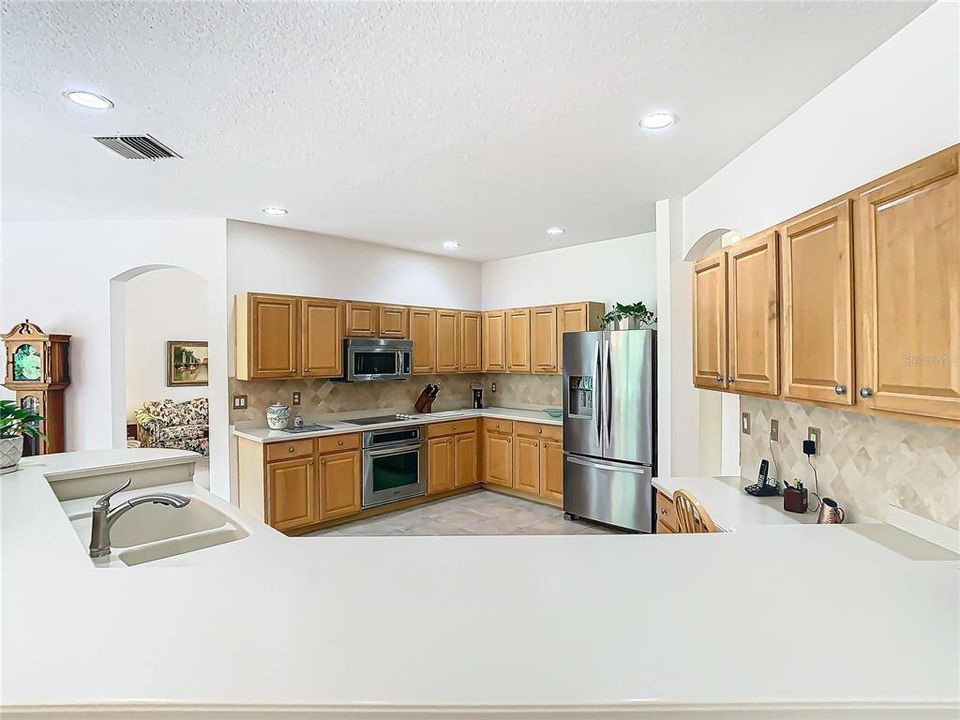 Spacious kitchen with quartz counters and stainless appliances.