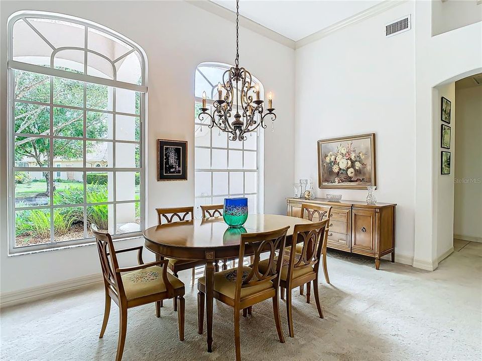 Formal dining room with exceptional light from the high windows.