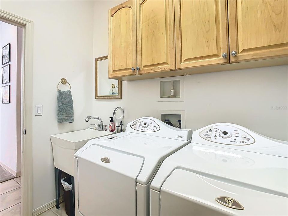 Separate laundry room with utility tub (washer/dryer convey)