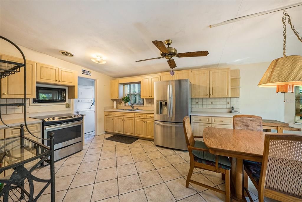 Eat-in kitchen with door to laundry/utility room