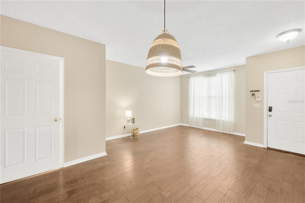 Stepping inside, you will see Hand scraped, wide planked, engineered hardwood throughout the 1st floor.  The living/dining room is 20 x 11’ with high ceilings, neutral wall color and plenty of natural light and room for furniture.